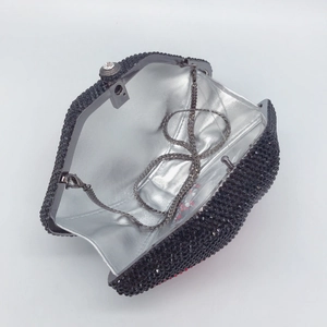 Internal view of black rhinestone evening clutch bag with silver lining and metal chain