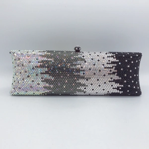Macro view of gradient rhinestone clutch bag with sparkling crystal ombre finish