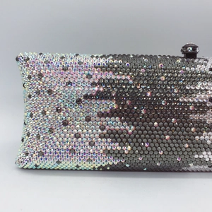 Macro detail of hand-set colorful gradient rhinestones on premium evening clutch bag