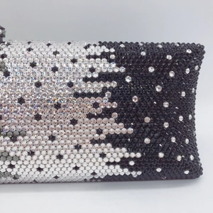 Detailed macro view of black and white gradient rhinestones on this luxury evening clutch bag