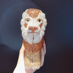 Detail of lion-shaped evening clutch with sparkling rhinestones and metal closure