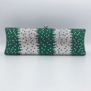 Close-up of luxury rectangular evening clutch with green and silver rhinestones