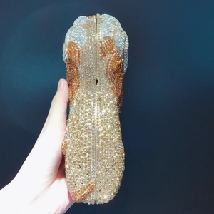 Detailed view of luxury lion shaped clutch bag with sparkling hand-set rhinestones
