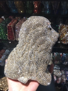 Close-up of a luxury lion-shaped evening clutch bag encrusted with sparkling crystals