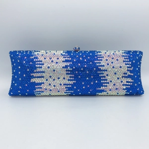 Close-up of blue and silver gradient rhinestone wavy pattern on elegant dinner clutch bag
