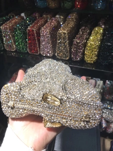 Detail of lion-shaped evening clutch featuring hand-set crystals and gold metal frame