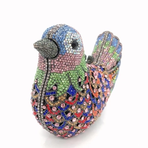 Detailed close-up of a bird-shaped evening clutch bag with colorful rhinestones and crystals