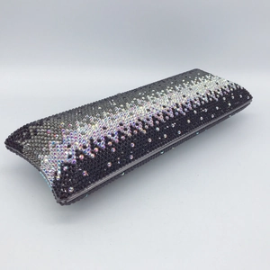 Macro side view of a luxury rectangle clutch bag featuring black to white gradient rhinestones
