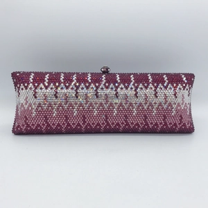 Detailed view of handmade evening clutch featuring purple gradient rhinestones and metal clasp