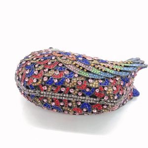 Detailed close-up of bird-shaped evening clutch bag with multicolor sparkling crystals