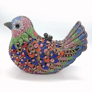 Detail of colorful crystals and gemstone clasp on the bird-shaped evening clutch bag