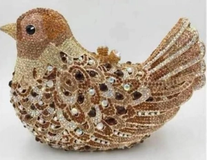 Detailed view of luxury bird shaped evening clutch with gold crystals and metal clasp