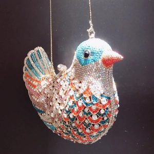 Detailed macro of bird shaped evening clutch with colorful sparkling rhinestones