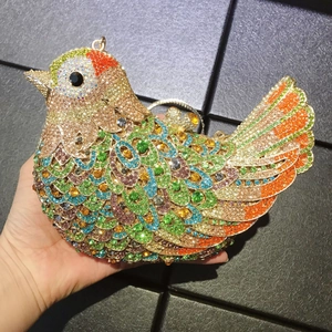 Detailed view of luxury bird-shaped evening clutch encrusted with colorful rhinestones