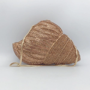 Champagne gold seashell clutch bag with sparkling rhinestones and a metal chain strap
