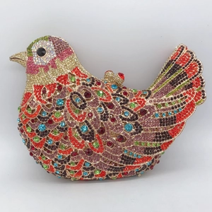 Macro shot of colorful crystal bird evening clutch bag with intricate rhinestone feather patterns