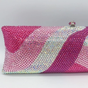 Macro detail of luxury evening clutch with pink and white rhinestone striped design