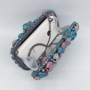 Luxurious skull evening clutch bag with multicolored crystals and metal chain
