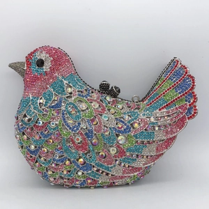 Detail of bird-shaped evening clutch with multi-color rhinestones and black bead clasp