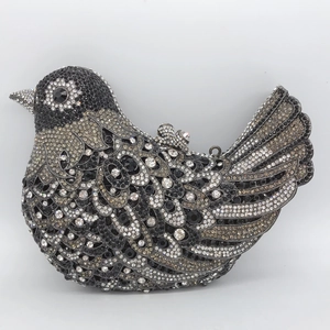 Detail of bird-shaped evening bag with hand-set grey and black sparkling crystals