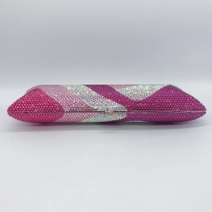 Macro detail of stripes on crystal evening clutch with pink rhinestones and metal clasp