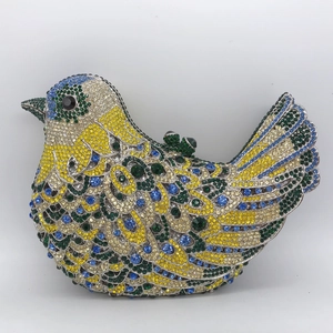 Macro detail of bird-shaped evening clutch bag with colorful rhinestones and crystal clasp