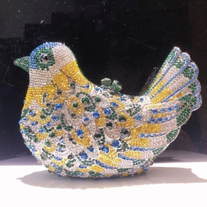 Detailed view of the vibrant bird-shaped evening clutch encrusted with colorful rhinestones
