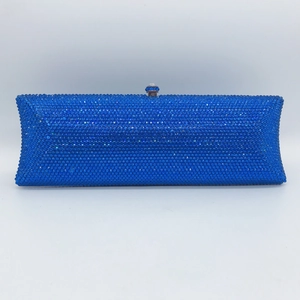 Close-up of royal blue rhinestones and crystal clasp on a rectangular evening clutch bag