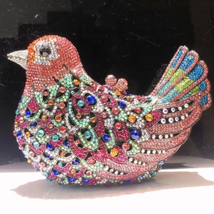 Detailed close-up of bird evening bag showing colorful crystal feathers and intricate stones
