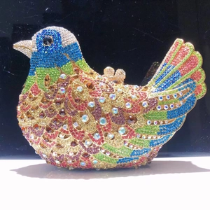 Macro detail of bird evening bag featuring multicolored rhinestones and metallic clasp