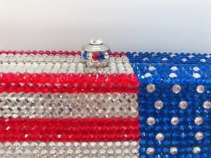Detailed close-up of crystal-encrusted American flag evening clutch with metal clasp