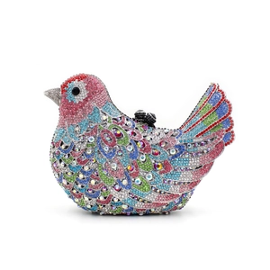 Detailed close-up of a bird-shaped evening clutch bag with multi-colored rhinestones