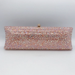 Close-up of pink and iridescent rhinestones on a luxury evening clutch with a gem lock