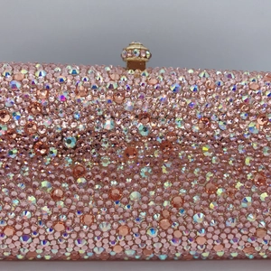 Close-up of luxury evening clutch showing detailed pink and AB color rhinestone crystal inlay