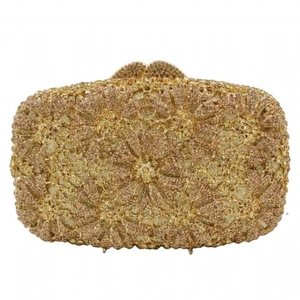 Close-up of golden hollow evening bag with floral diamond patterns and metallic clasp