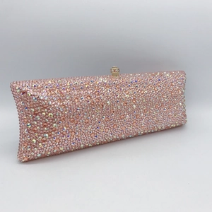 Close-up of pink crystal clutch with sparkling rhinestones and cylindrical clasp