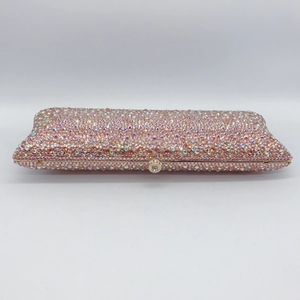 Detailed macro of pink rhinestone evening clutch with crystal lock and gold frame