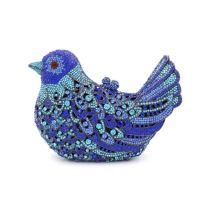 Detail of bird-shaped evening clutch bag with blue crystal rhinestones and red eye accent