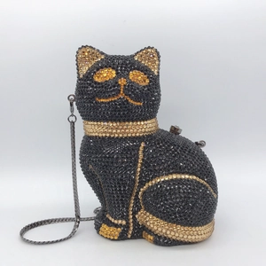 Detailed view of cat evening bag with hand-set black and gold rhinestones and chain