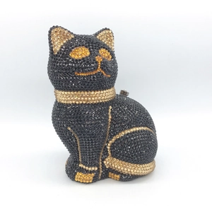 Detailed close-up of a luxury cat-shaped clutch bag with sparkling black and gold crystals