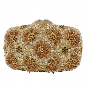Close-up of luxury gold evening clutch with hollow metal and sparkling rhinestones