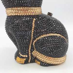 Macro detail of the side profile showing crystal studs on the cat shaped evening clutch