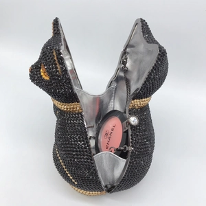 Inside view of a cat-shaped crystal evening bag with silver lining and metal chain