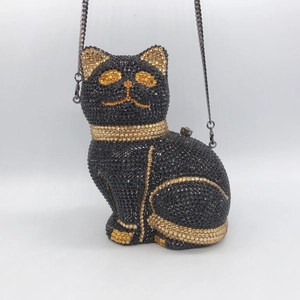 Detailed view of luxury cat-shaped clutch bag with black and gold crystal rhinestones