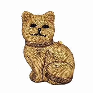 Macro shot of a cat-shaped evening clutch bag with sparkling golden rhinestones