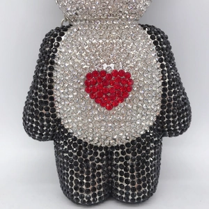 Macro detail of the bear evening bag featuring full rhinestone inlay and heart motif
