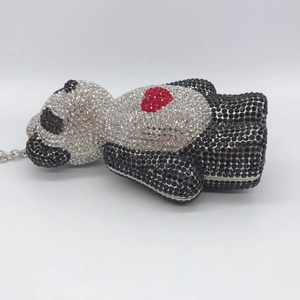 Detailed side view of panda evening bag with sparkling crystals and red heart