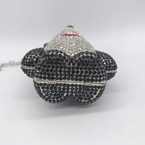 Detail view of the silver metal hinge and rhinestone texture on the panda evening bag