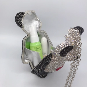 Macro shot of panda-shaped crystal evening bag with silver lining and metal chain