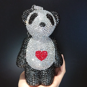 Macro detail of a panda-shaped rhinestone pendant with red heart and sparkling crystals